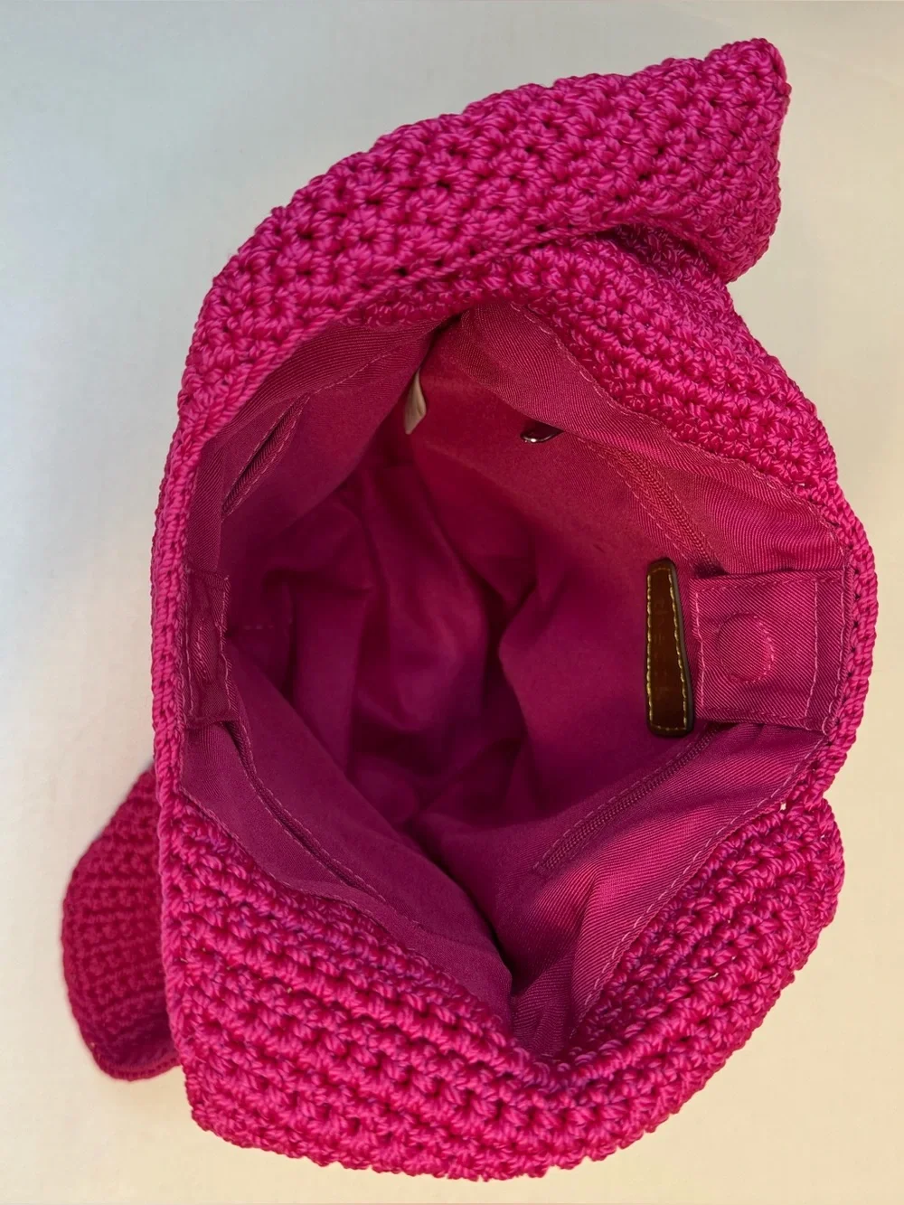 The Sak raspberry, pink handcrafted crochet hobo shoulder bag